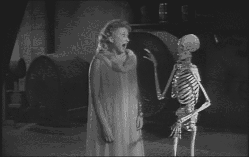 skeleton pushing a woman into a hole